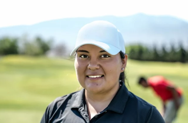 Volunteer in a cap at a golf tournament