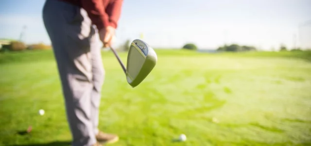 Golfer at address with the driver head behind the ball