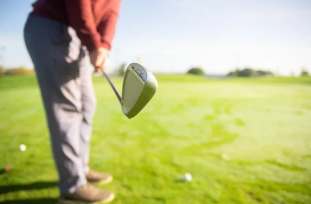 Golfer at address with the driver head behind the ball
