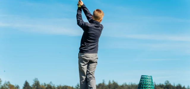 Young golfer at the end of the swing