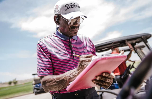 Golfer looking at a scorecard