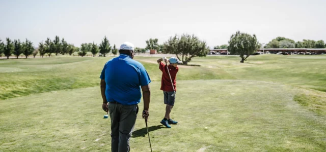 Two golfers waiting on the tee