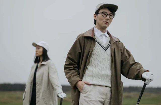 Two golfers in coats and jumpers in cold weather