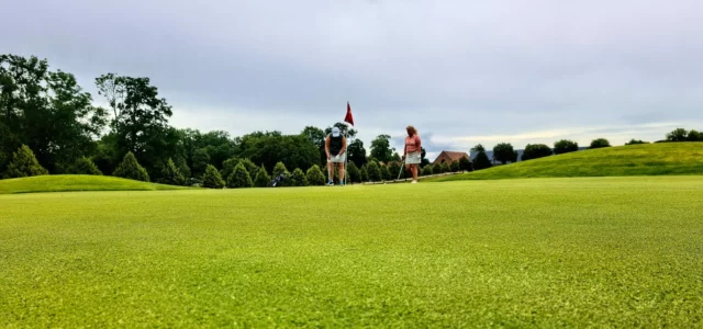 Distant green with the flag and players