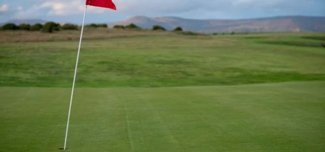 Drapeau rouge planté sur un green